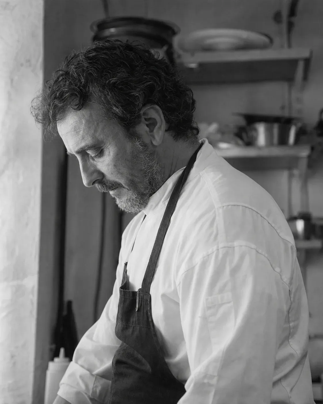 Black and white candid portrait of Chef Elia Marchetti in profile